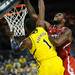 Michigan freshman Glenn Robinson III is fouled by North Carolina State senior Richard Howell during the first half at Crisler Center on Tuesday night. Melanie Maxwell I AnnArbor.com